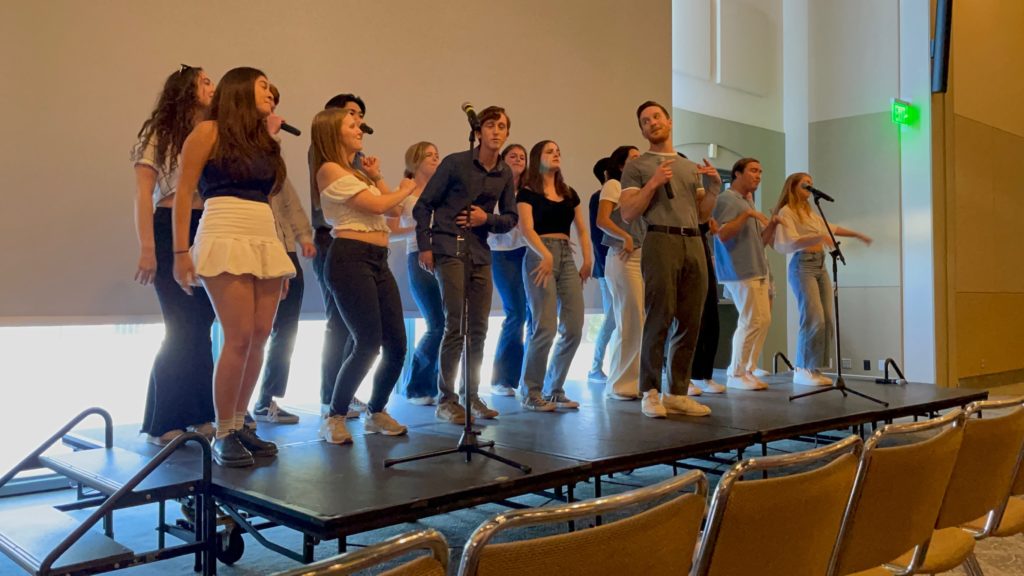 Members of Take It SLO rehearse on a stage. 