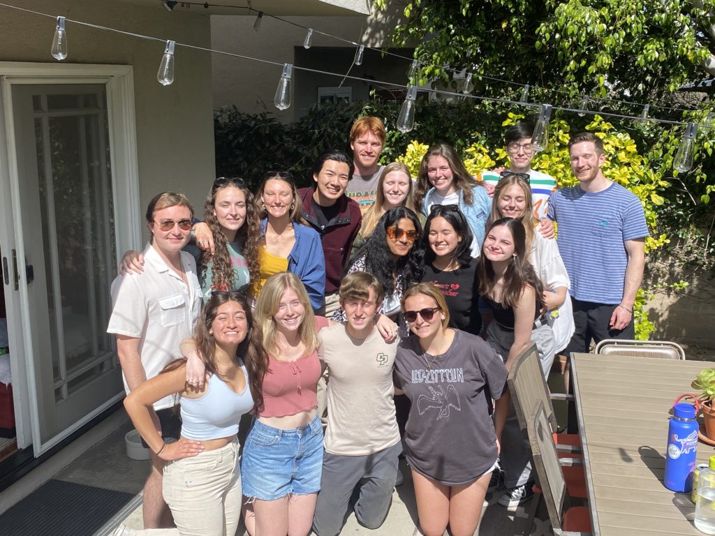 Members of Take It SLO pose for a photo in a backyard. 