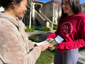 photo of two people echanging pamphlets